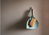 Wall-mounted dustpan for convenient furniture cleaning
