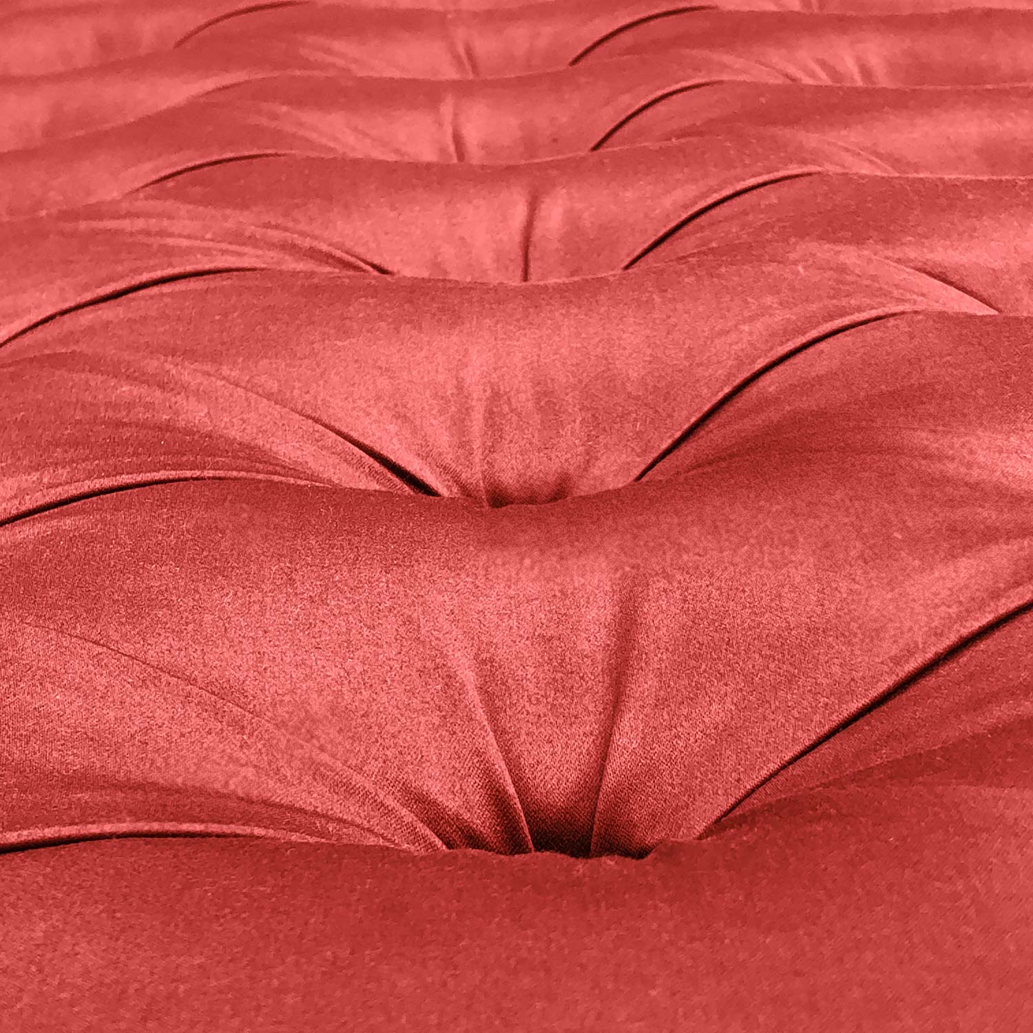 detail of satin capitonne upholstery in red