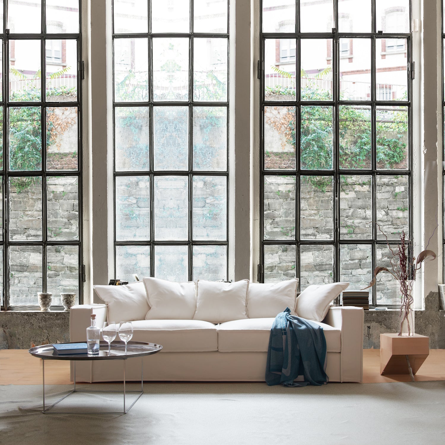 Deep Seats for a Pleasurable Seating Experience. Rafaella sofa in front of industrial window.