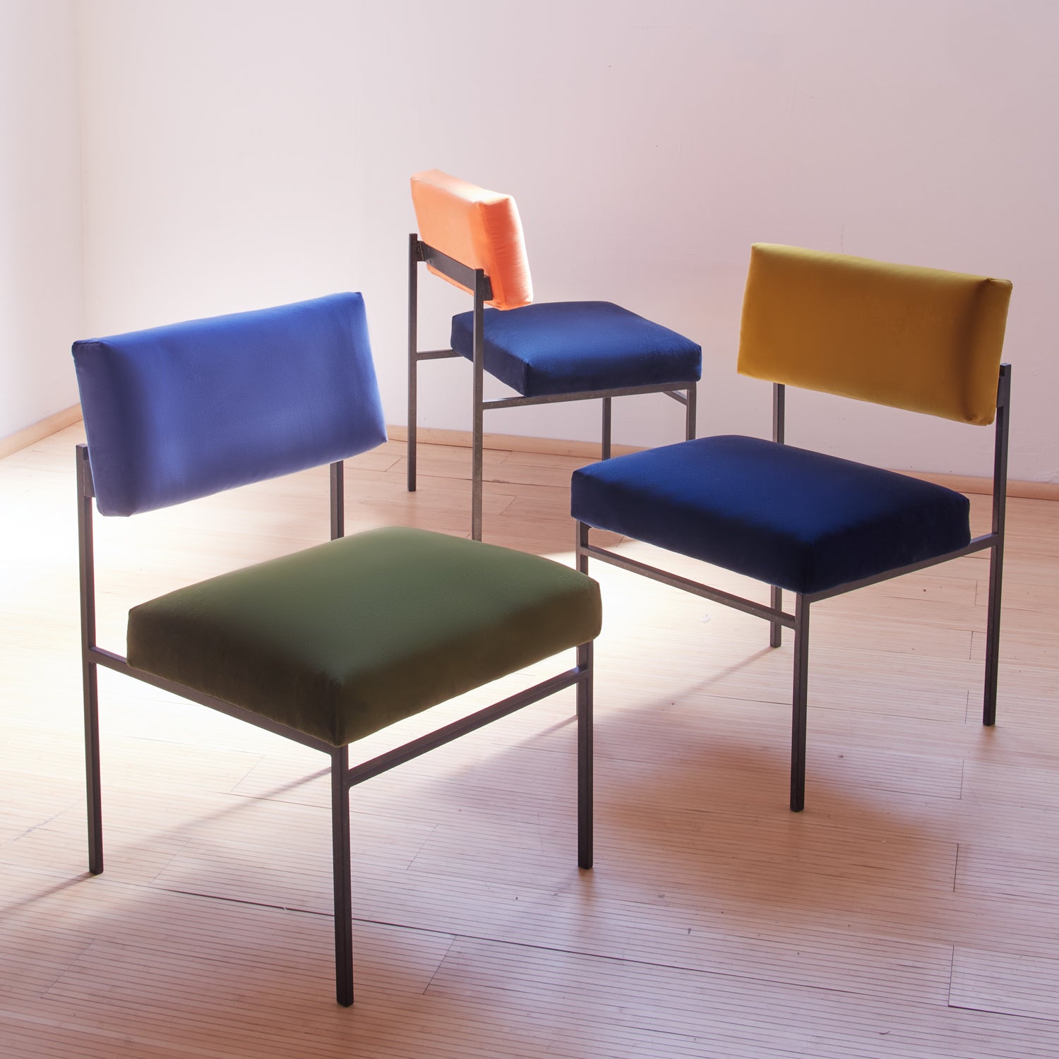 organic dining chairs in variations of green, blue and orange velvet